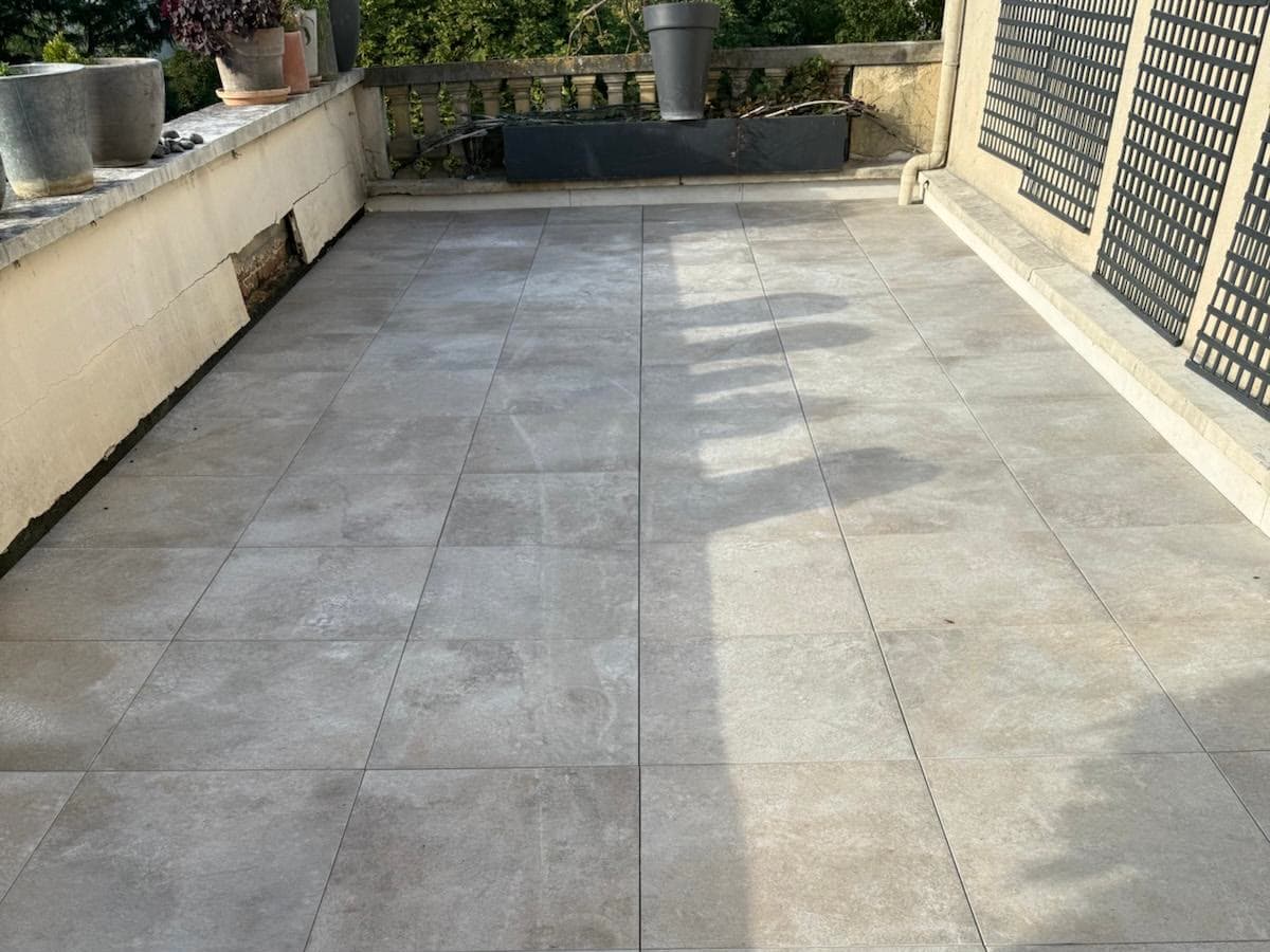 Terrasse accessible d'un particulier : dalles en grès cérame posées sur plots au-dessus du complexe d'étanchéité